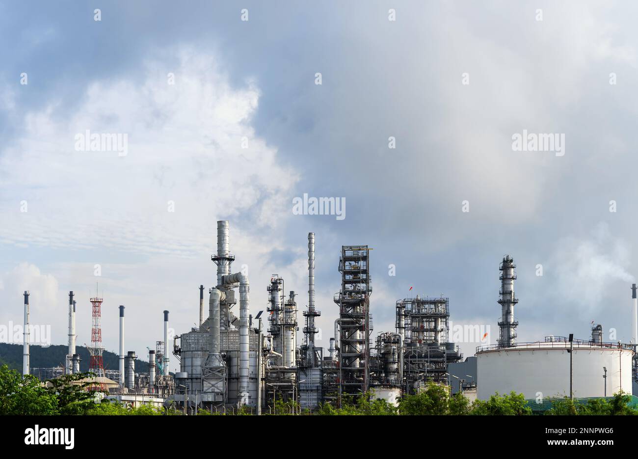 Oil and gas refinery plant and storage tank form industry zone with Air pollution smoke, Oil and gas Industrial petrochemical fuel power and energy. R Stock Photo