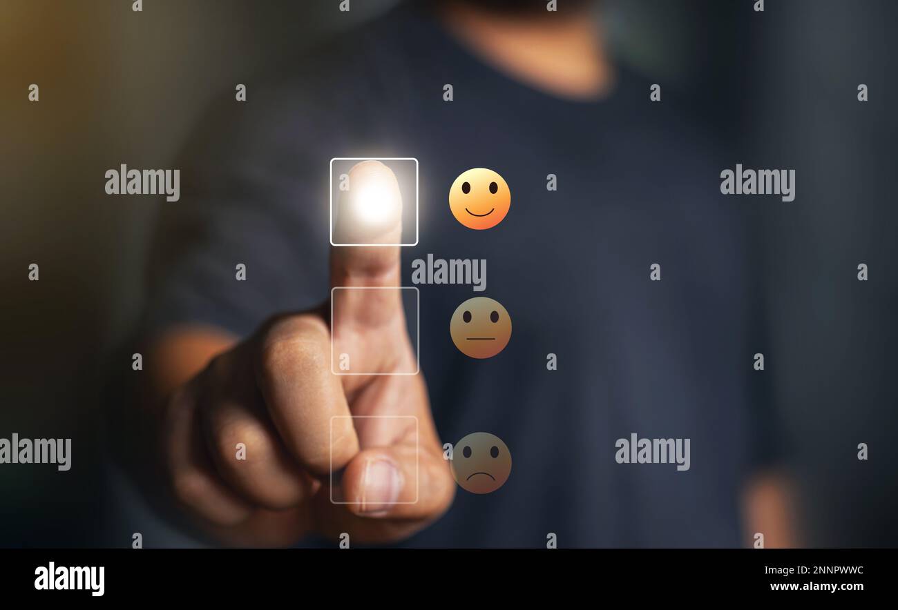 Feedback rating concept, Man choosing smiley face icon. feedback rating and positive customer review experience, business man select happy on satisfac Stock Photo