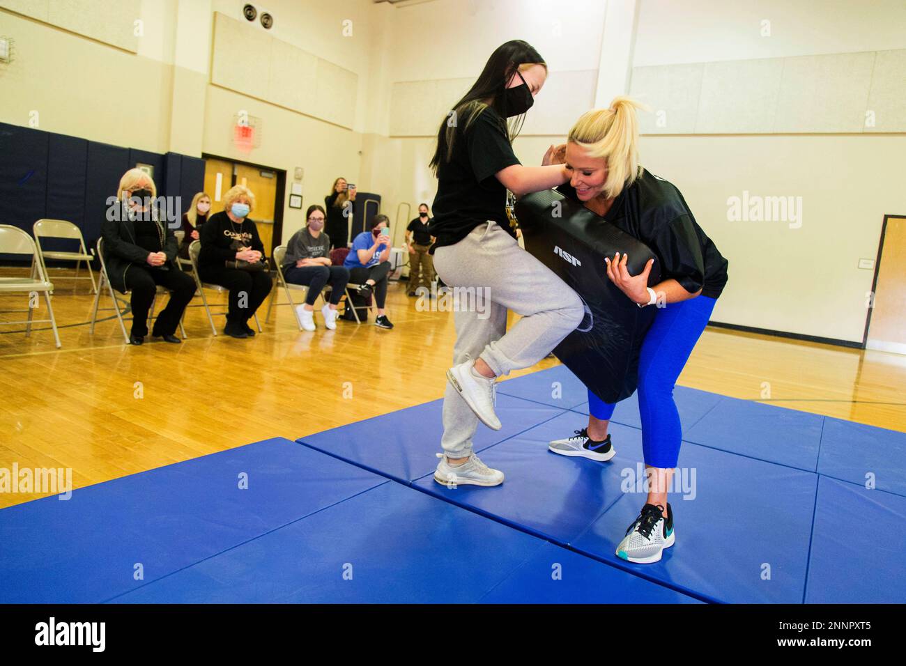 Alexis Alsip, left, practices a knee strike with police officers during
