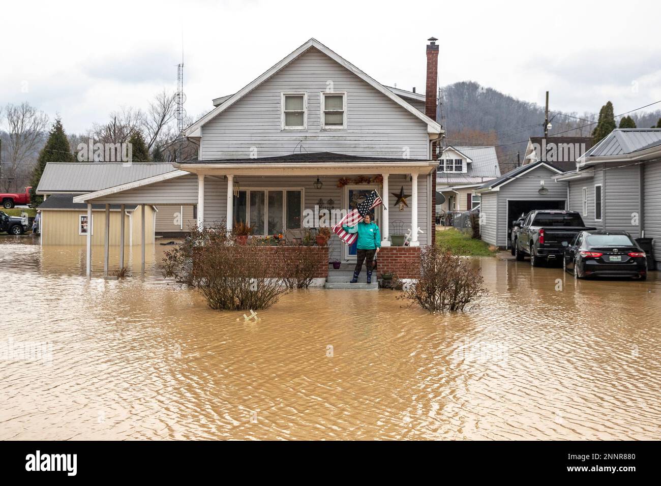 Catherine Castle stands on the porch of her home in downtown