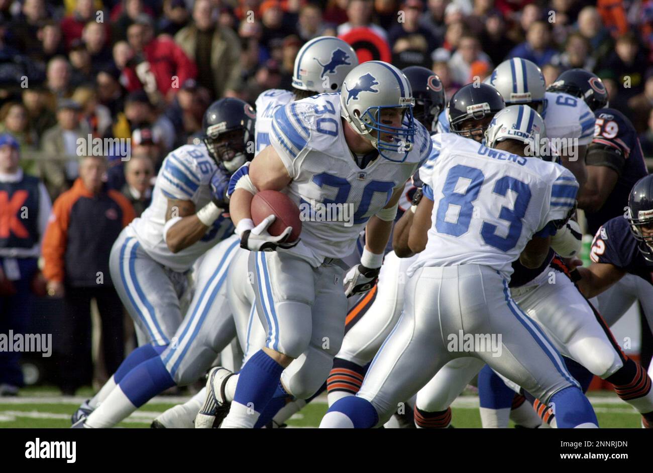 Detroit Lions fullback Cory Schlesinger (30) wears the new Detroit Lions  home uniform while defensive end Kalimba Edwards (98) wears the new road  uniforms in Detroit, Wednesday, April 23, 2003. On the