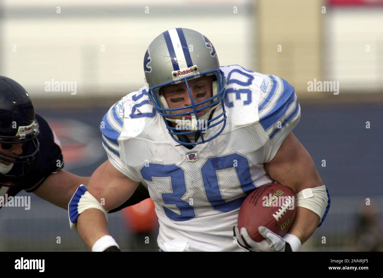 Detroit Lions fullback Cory Schlesinger (30) wears the new Detroit Lions  home uniform while defensive end Kalimba Edwards (98) wears the new road  uniforms in Detroit, Wednesday, April 23, 2003. On the