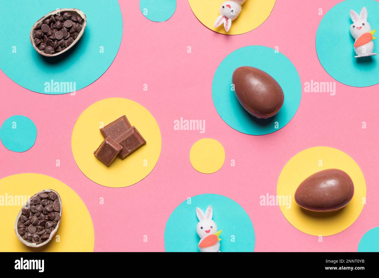 overhead view easter eggs rabbit choco chips round frame pink