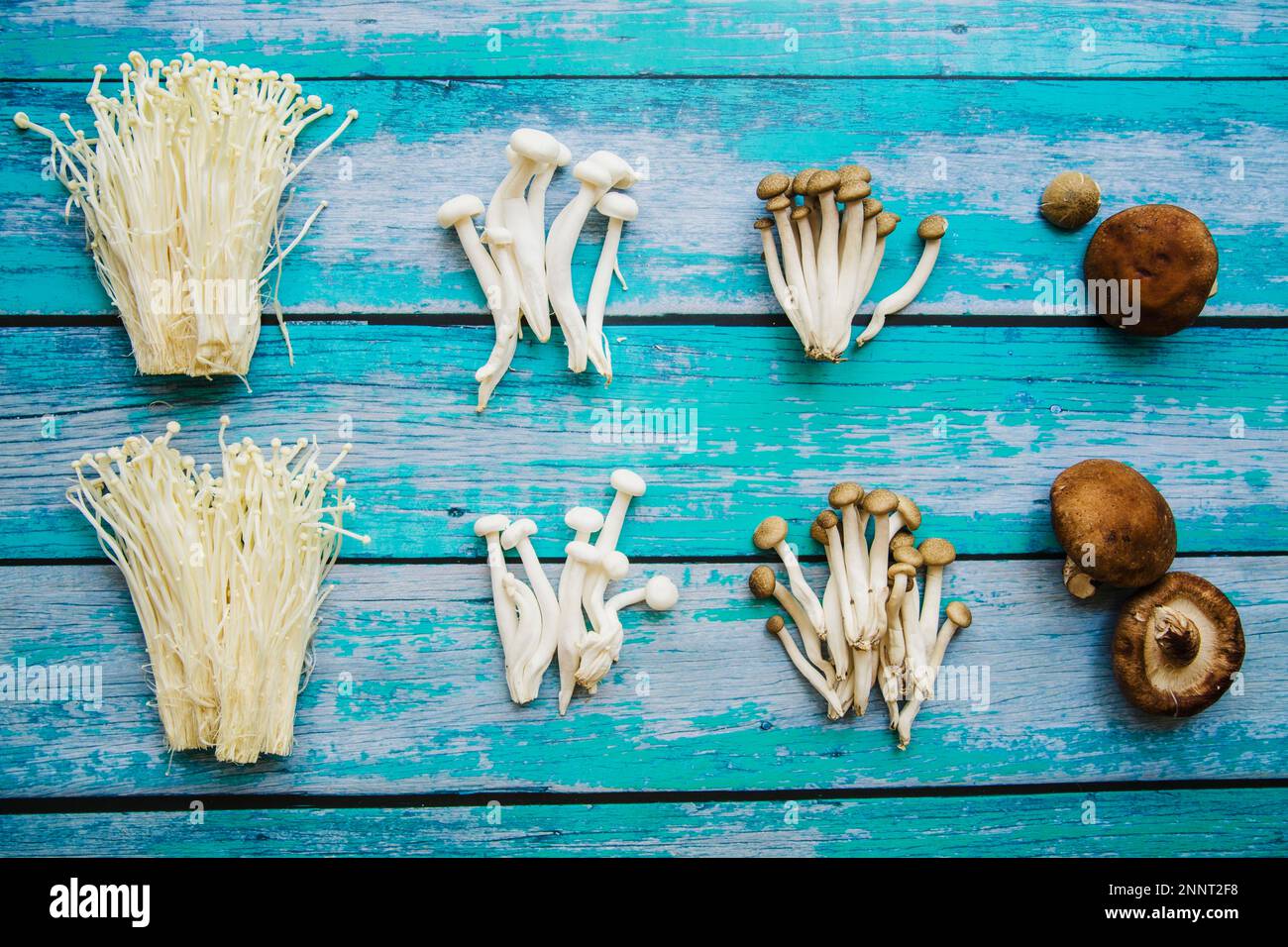 various types raw healthy mushrooms arranged old wooden table Stock Photo