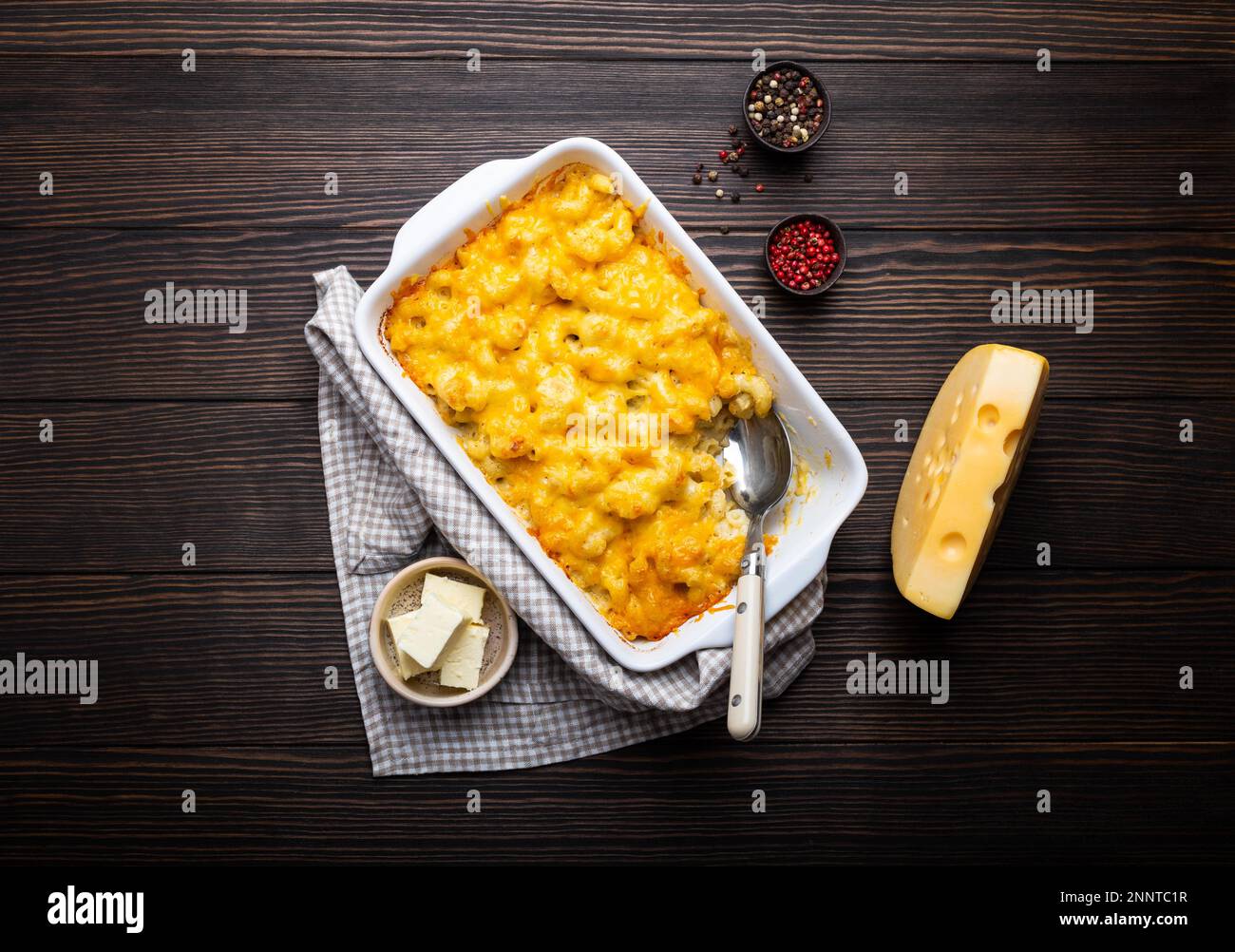 Closeup of baked mac and cheese in white casserole on rustic wooden