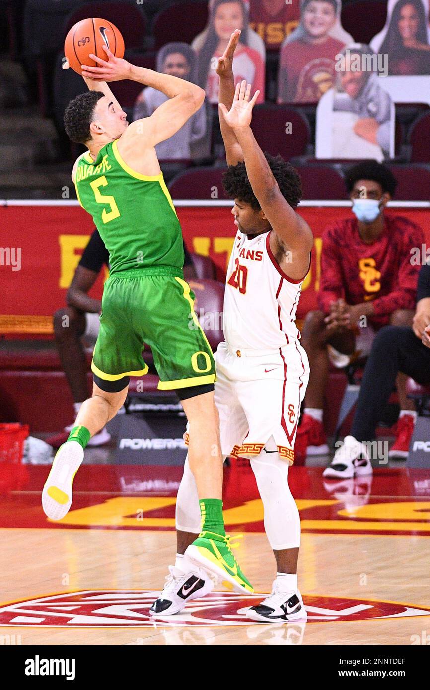LOS ANGELES, CA - FEBRUARY 22: Oregon guard Chris Duarte (5), defended  closely by USC Trojans forward Max Agbonkpolo (23), tries to make a pass  during the college basketball game between the
