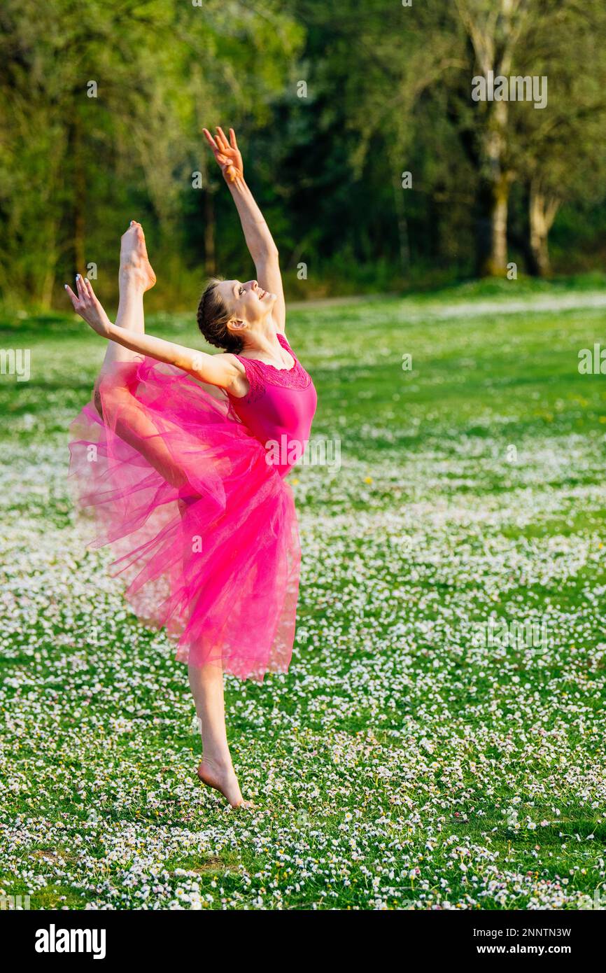Ballerina dancing on lawn with flowers, Battle Point Park, Bainbridge Island, Washington, USA Stock Photo
