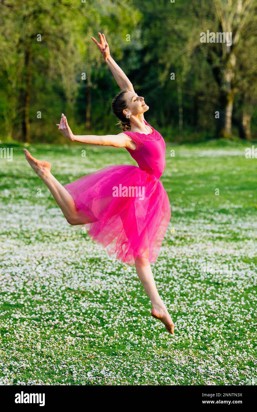 Ballerina dancing on lawn with flowers, Battle Point Park, Bainbridge Island, Washington, USA Stock Photo