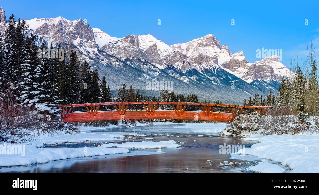 Mt Rundle Canmore Footbridge over Policemans Creek in snowy mountain landscape with Mount ...