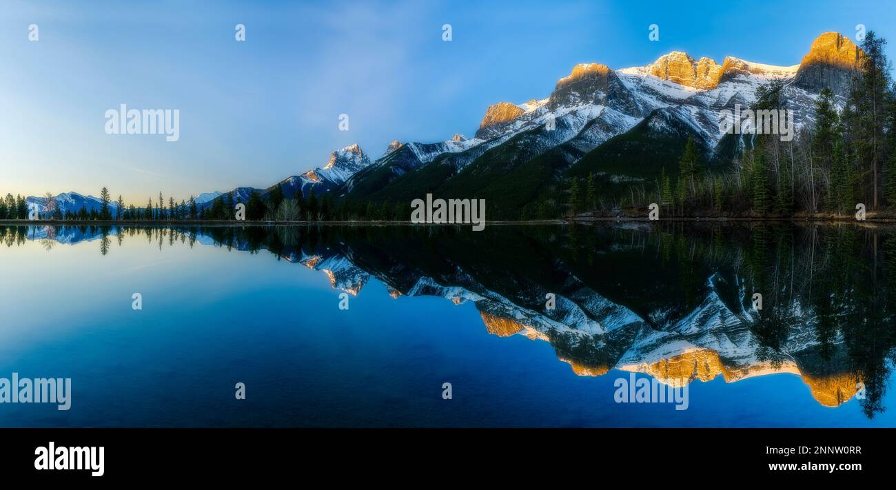 Mountain range reflected in Rundle Forebay, Canmore, Alberta, Canada Stock Photo