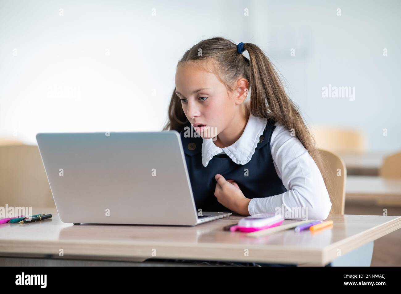 Caucasian girl studying on a laptop in a classroom Stock Photo - Alamy