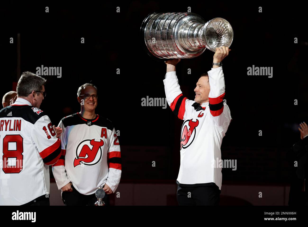 The 2003 Stanley Cup Champion New Jersey Devils pose for a team photo after  a ceremony honoring the 20-year anniversary before an NHL hockey game  against the Philadelphia Flyers, Saturday, Feb. 25