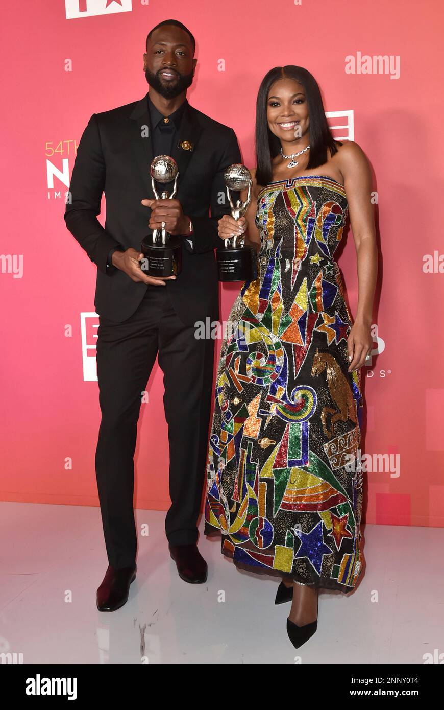 Dwyane Wade, left, and Gabrielle Union-Wade pose with the president's