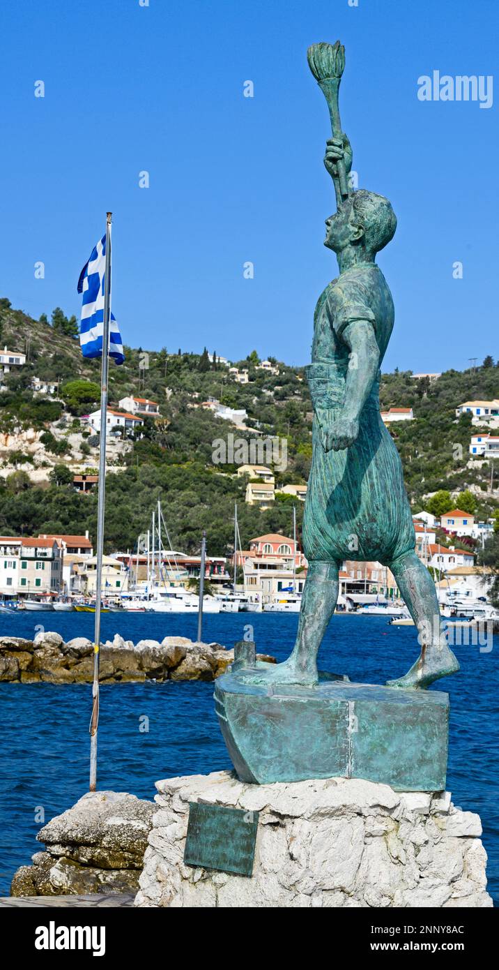 Statue of Georgios Anemogiannis and Greek flag, Gaios, Paxos, Ionian Islands, Greece Stock Photo