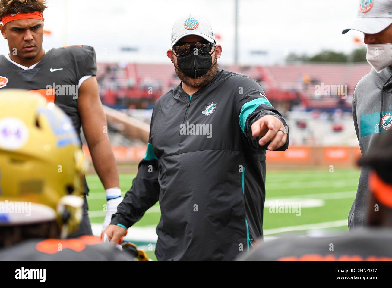 Miami Dolphins outside linebackers coach Ty McKenzie walks onto the field  before an NFL football game against the Houston Texans, Sunday, Nov. 27,  2022, in Miami Gardens, Fla. (AP Photo/Doug Murray Stock