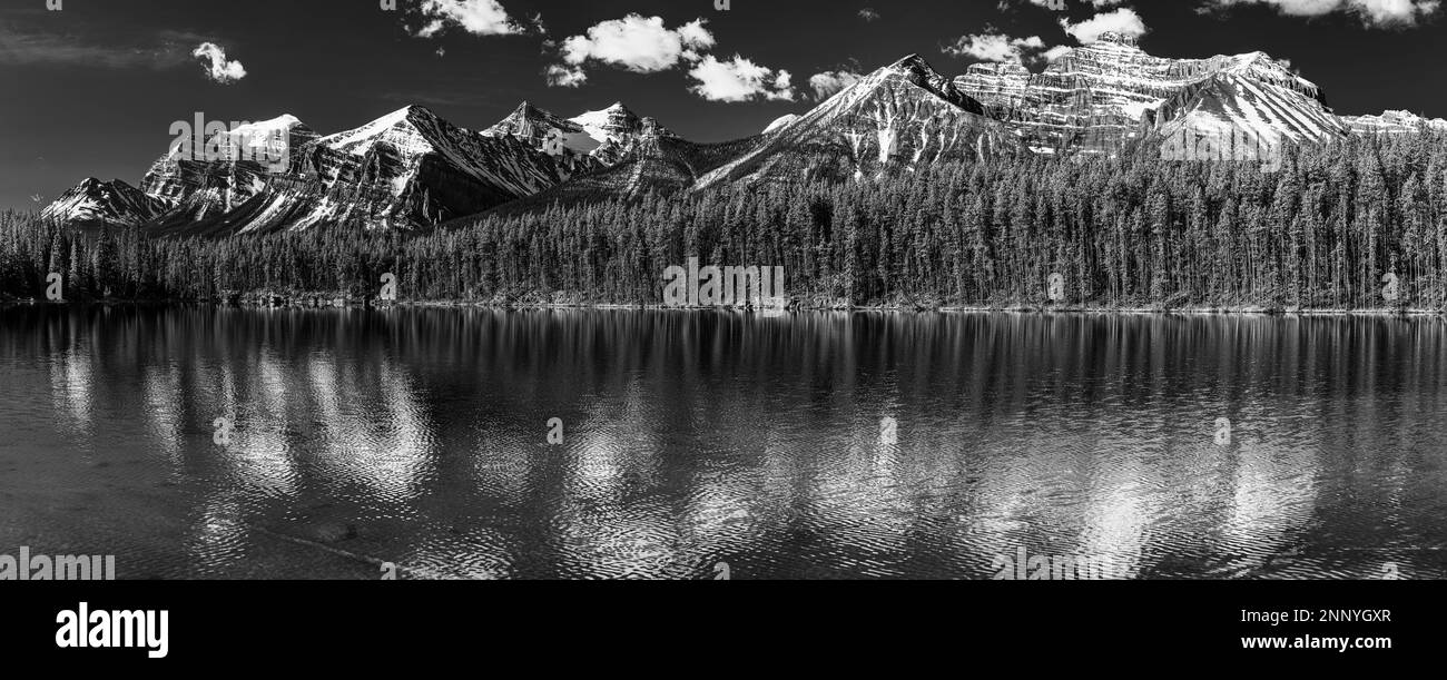 Snow-covered mountain peaks and Herbert Lake, Mt. Temple, Mt. Fairview, Mt. Saint Piran, Lake Louise, Alberta, Canada Stock Photo