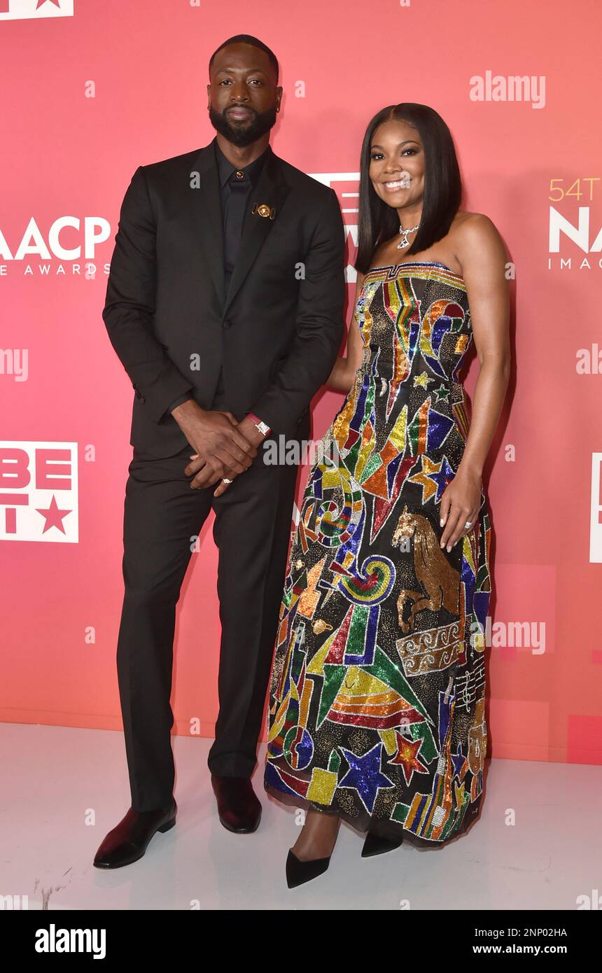 Dwyane Wade, left, and Gabrielle Union-Wade pose with the president's