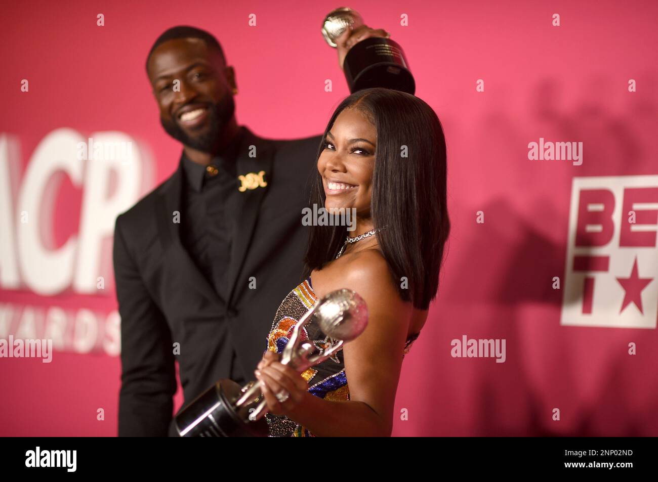 Dwyane Wade, left, and Gabrielle Union-Wade pose with the president's