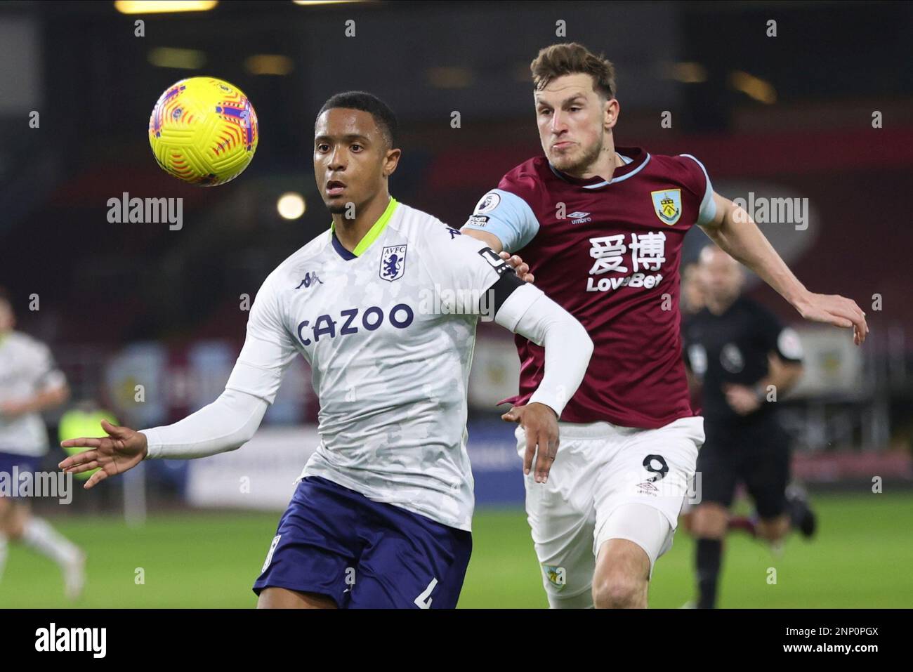 Aston Villa's Ezri Konsa, left, and Burnley's Chris Wood challenge for ...