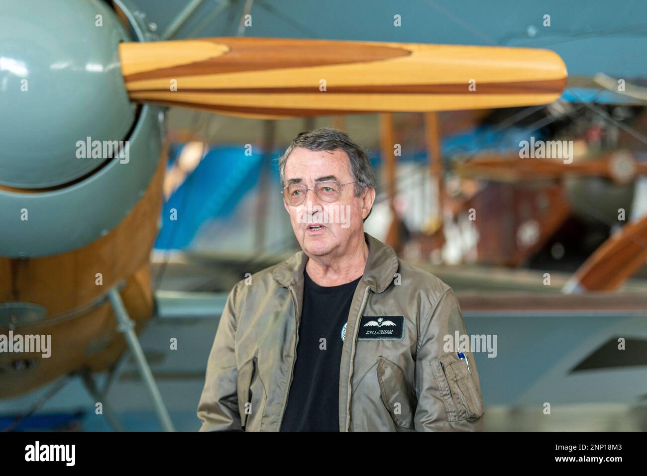 John Lanham, pilot with Vintage Aviator Ltd in hangar at Hood Aerodrome, Masterton, New Zealand with World War One reproduction aircraft and exhibits Stock Photo