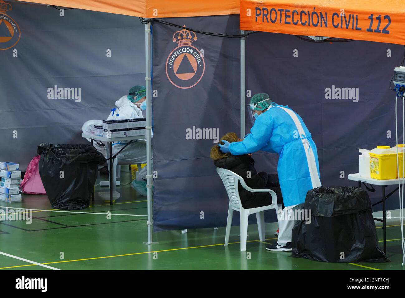 A protected health worker performs an antigen test at the Municipal