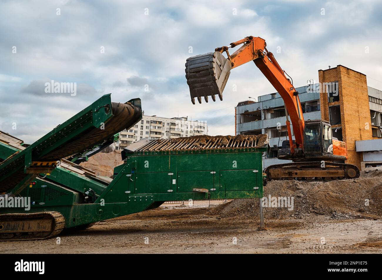 Excavator loads soil in mobile crushing and sorting complex Stock Photo