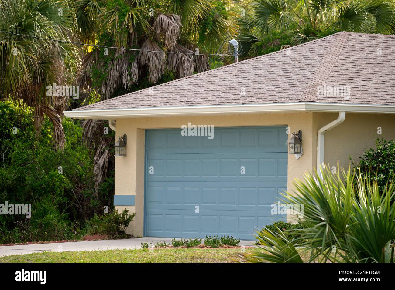 Wide garage double door and concrete driveway of new modern american
