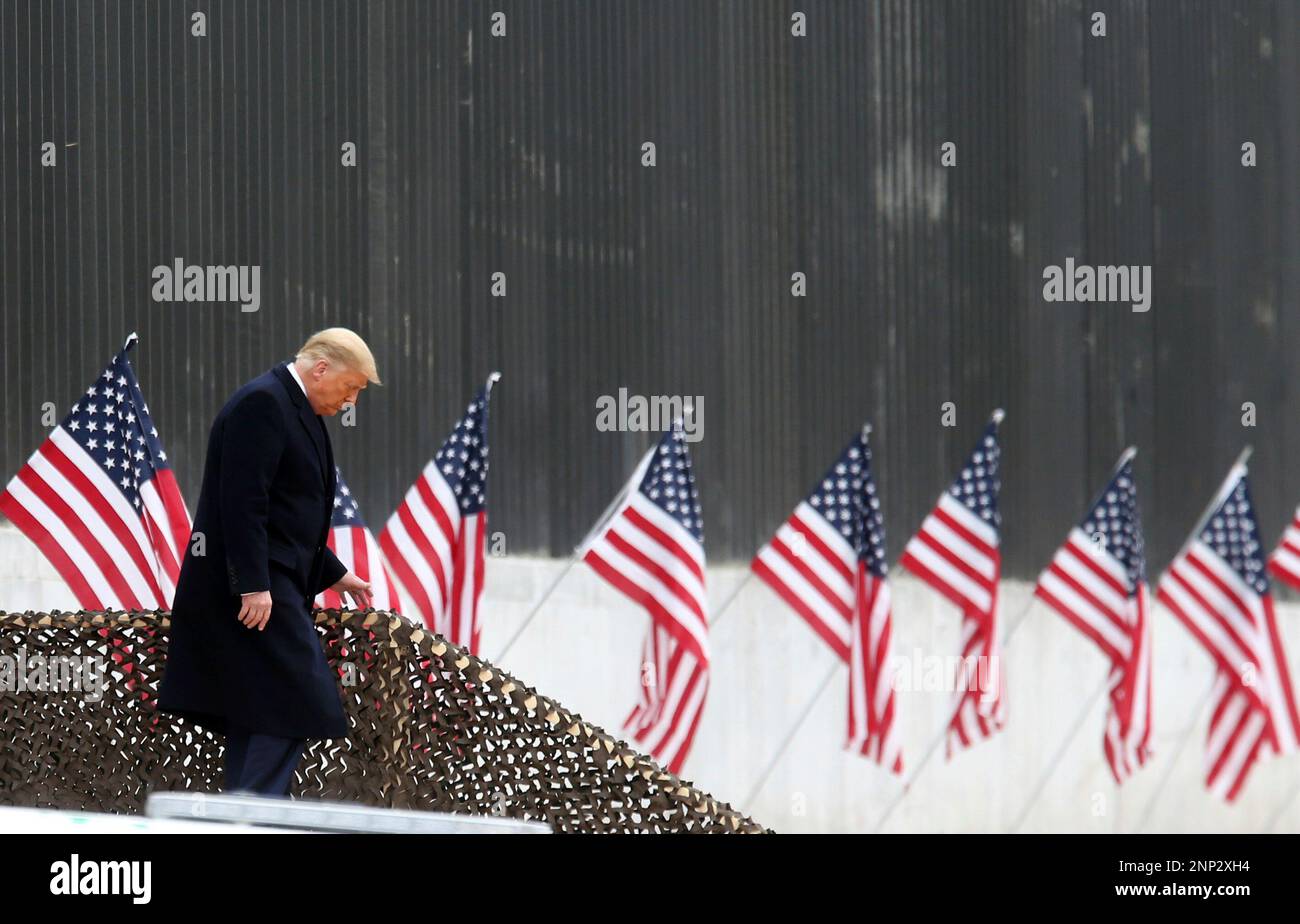 President Donald Trump walks down the steps before a speech near a ...