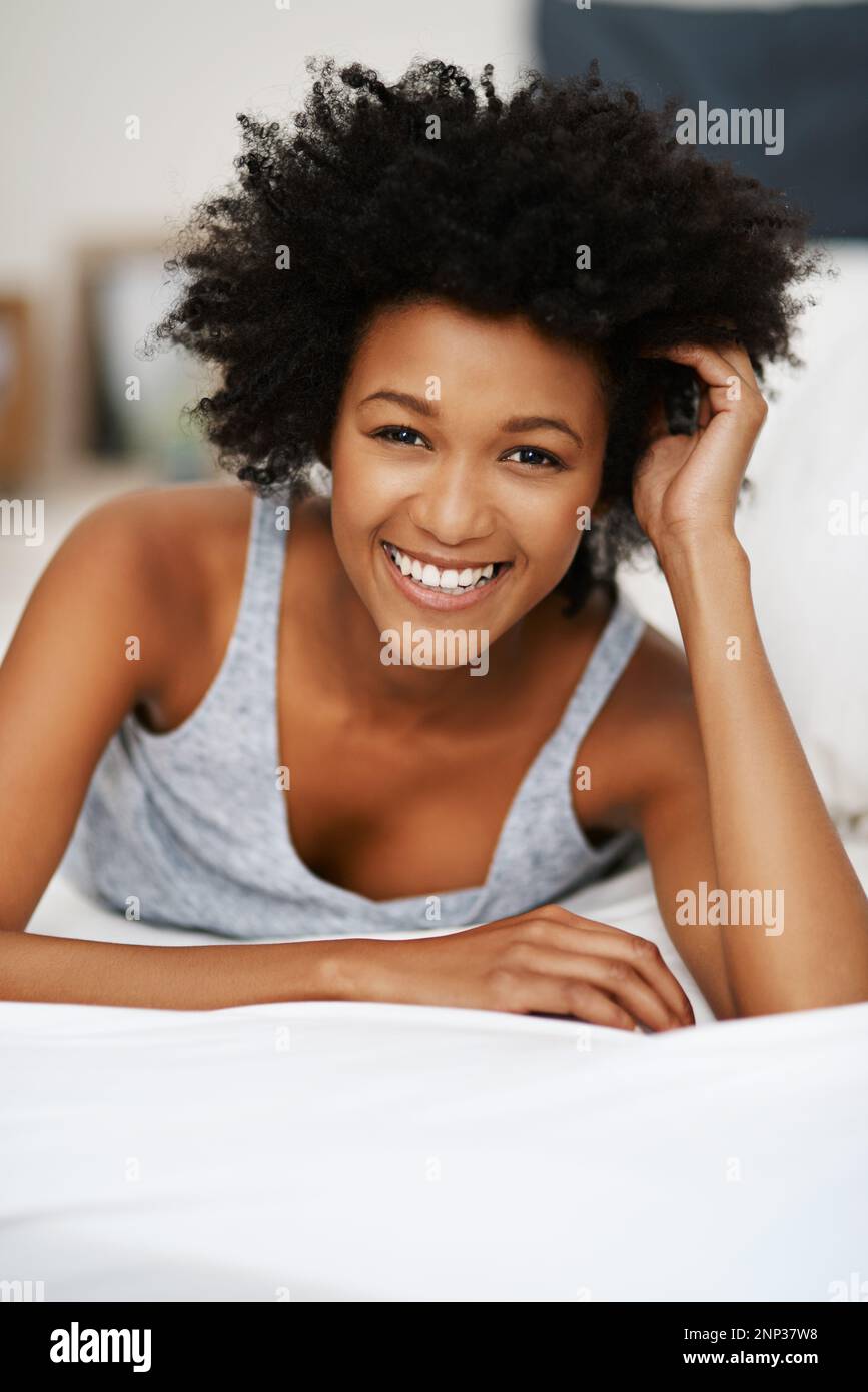 Good morning to you too. Portrait of a happy young woman relaxing in