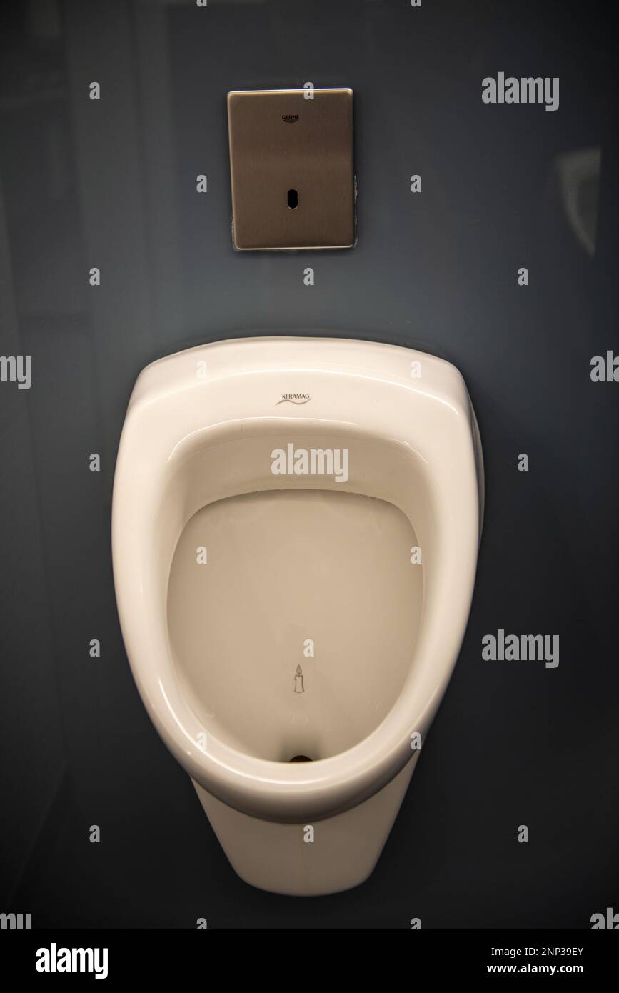 Close up of urinal with candle drawn inside Stock Photo