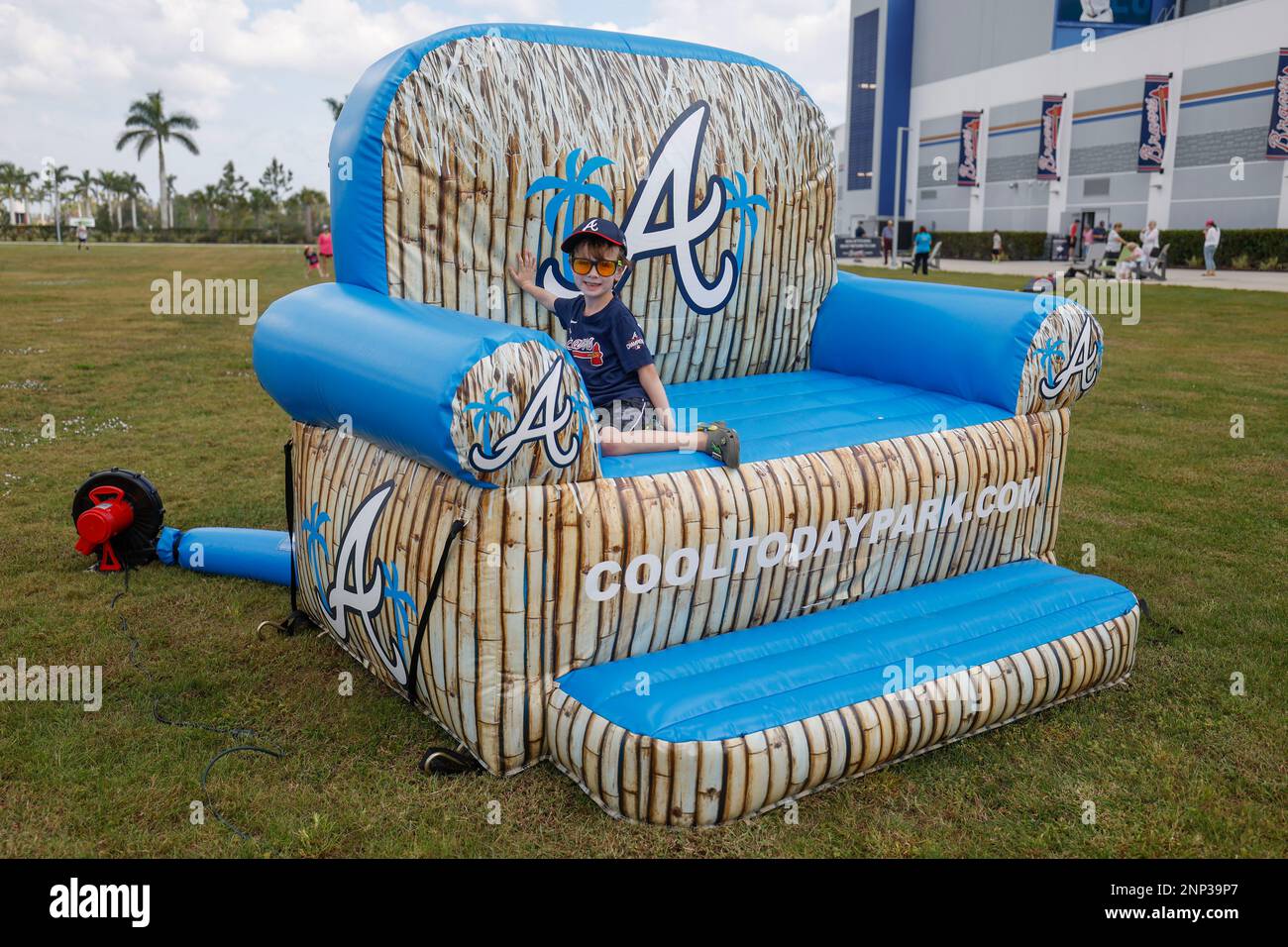 North Port FL USA: A young fan enjoys an oversized arm chair during an MLB spring training game between the Atlanta Braves and the Boston Red Sox at C Stock Photo