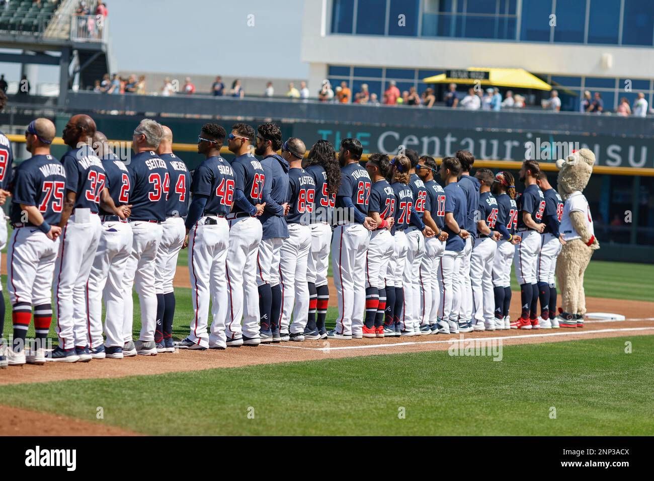 North Port FL USA: The Atlanta Braves stand at the singing of our National Anthem prior to an MLB spring training game against the Boston Red Sox at C Stock Photo