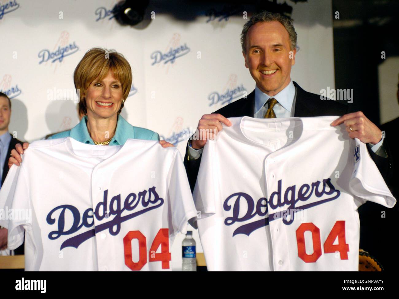 New Los Angeles Dodgers owners Jamie (left) and Frank McCourt hold jerseys at press conference