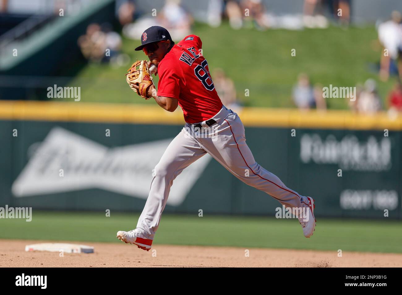 North Port FL USA: Boston Red Sox third baseman Enmanuel Valdez (83) runs to field a hard hit ball and throws to first for the out during an MLB sprin Stock Photo