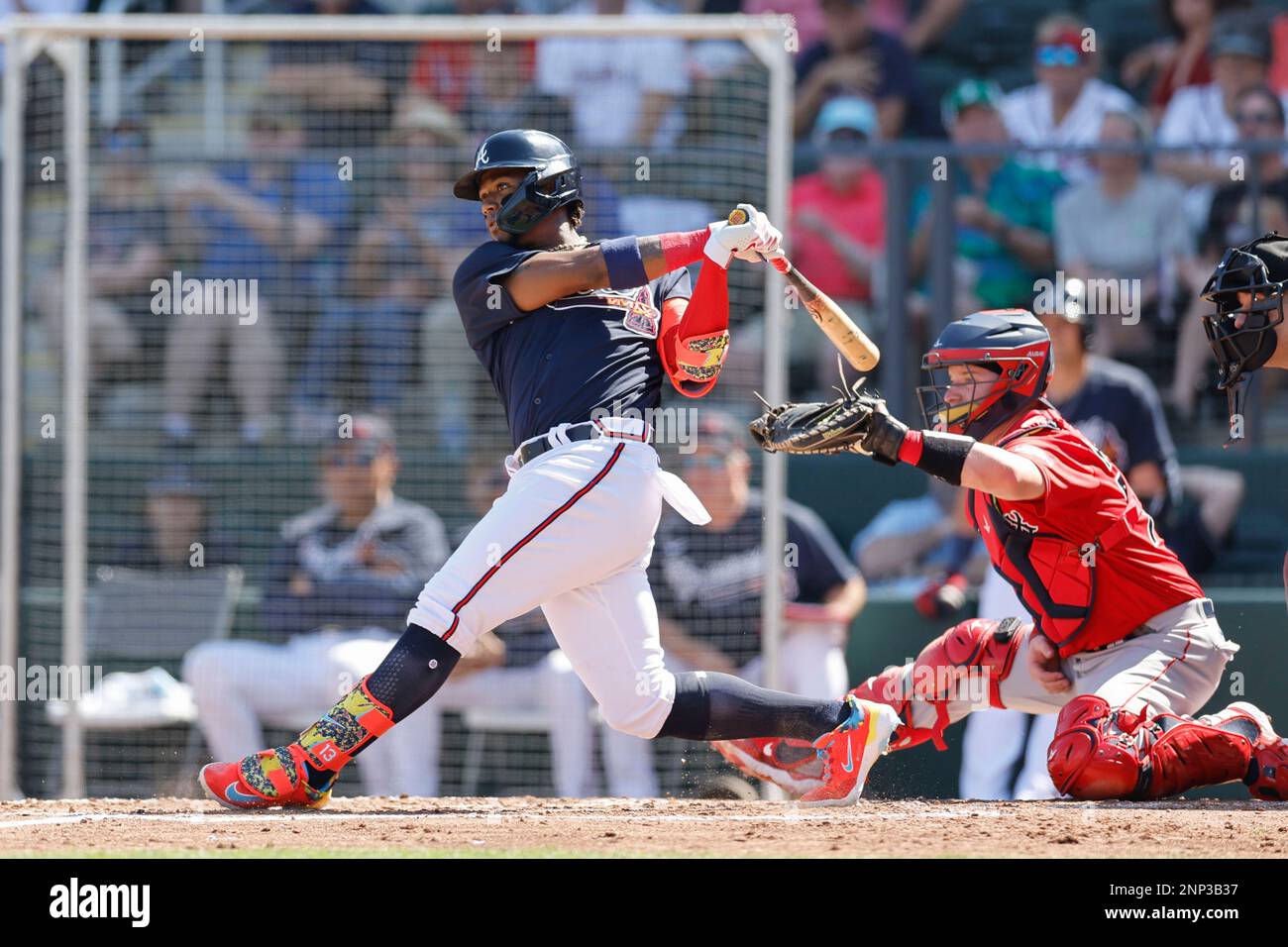 North Port FL USA: Atlanta Braves right fielder Ronald Acuna Jr. (13) hits a single to left field during an MLB spring training game against the Bosto Stock Photo
