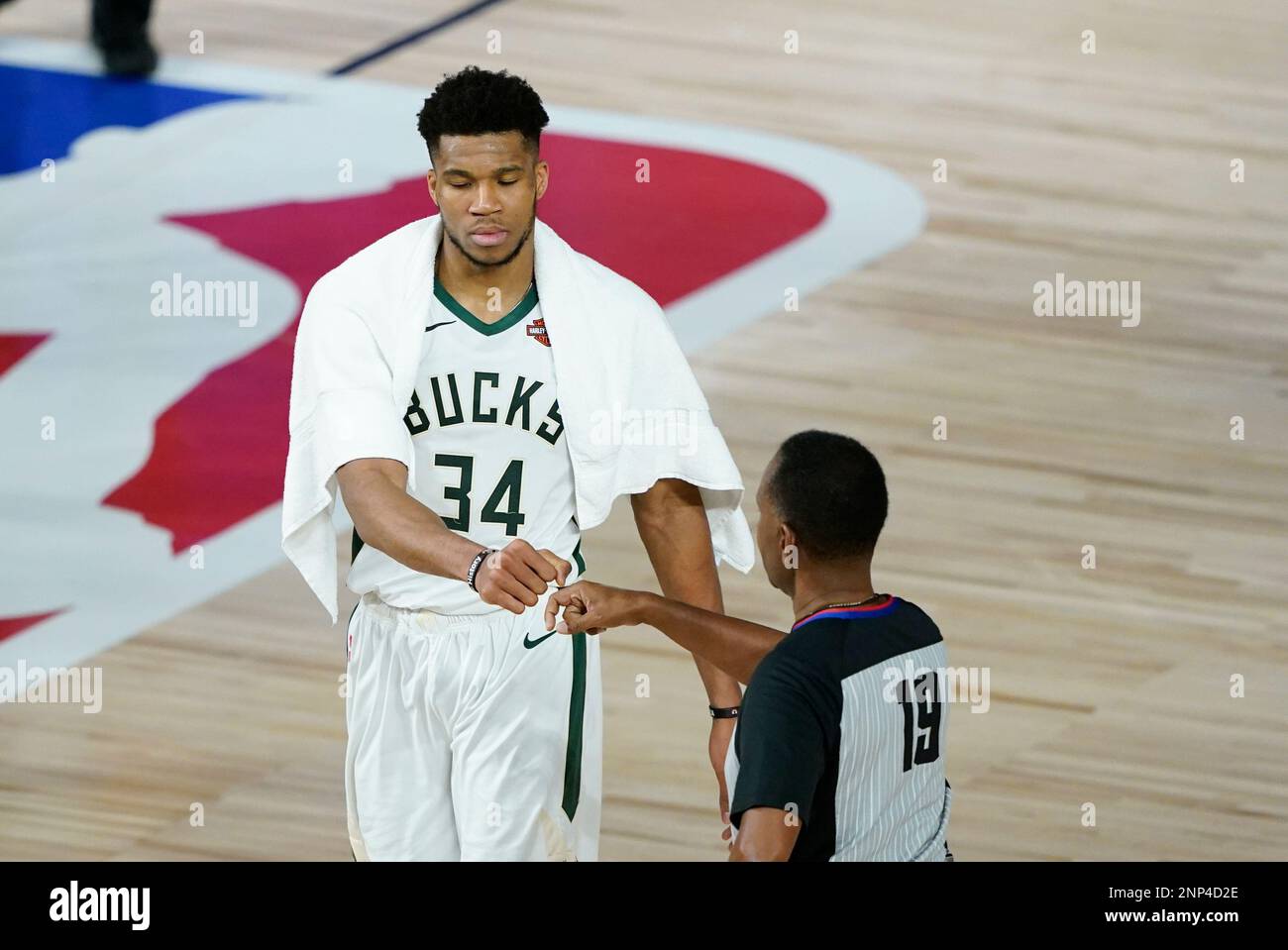 FILE Milwaukee Bucks' Giannis Antetokounmpo (34) fist bumps referee