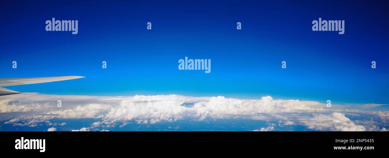 View of blue sky and clouds from airplane window Stock Photo - Alamy
