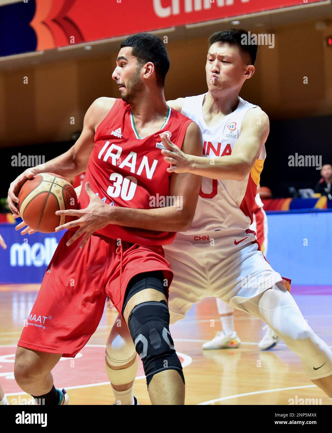 Hong Kong, China. 26th Feb, 2023. Zhou Peng (R) of China vies with Jalal Agha Miri of Iran during the Group F match between China and Iran of FIBA Basketball World Cup Asian Qualifiers in Hong Kong, south China, Feb. 26, 2023. Credit: Lo Ping Fai/Xinhua/Alamy Live News Stock Photo