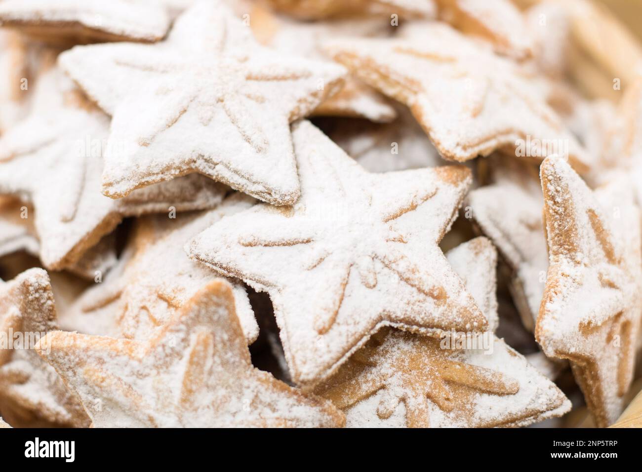 Star-shaped cookies close-up, selective focus, bokeh. Christmas baking. Shortbread. Gingerbread cookie. Homemade baking. Stock Photo