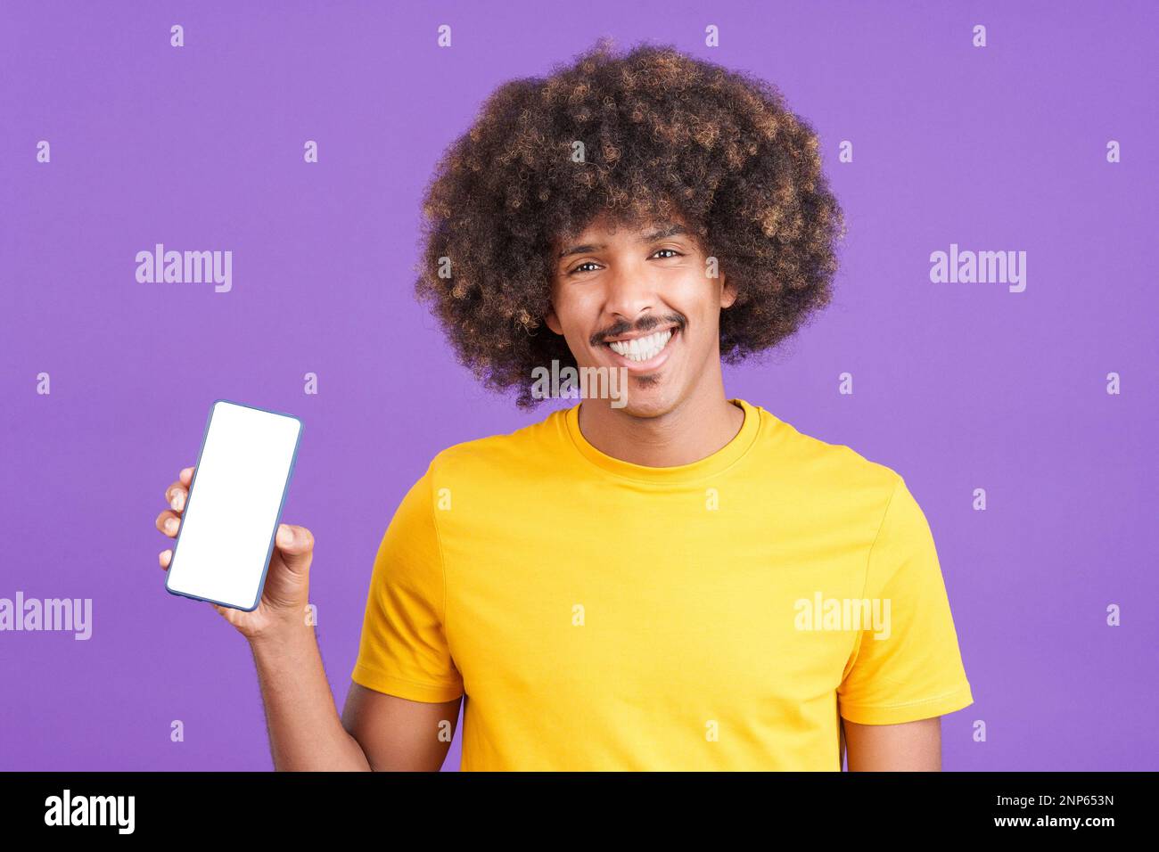 Happy african man holding a mobile with a blank screen Stock Photo