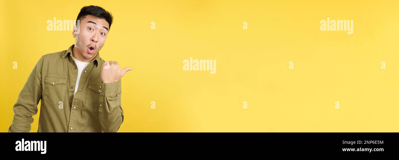 Amazed chinese man pointing surprised to the side Stock Photo - Alamy