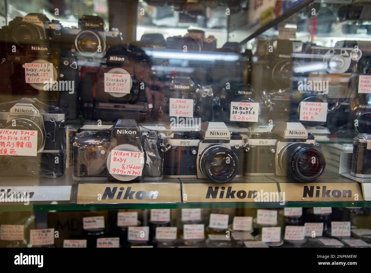 Bunch of old reflex film cameras on a Hong Kong store window with a