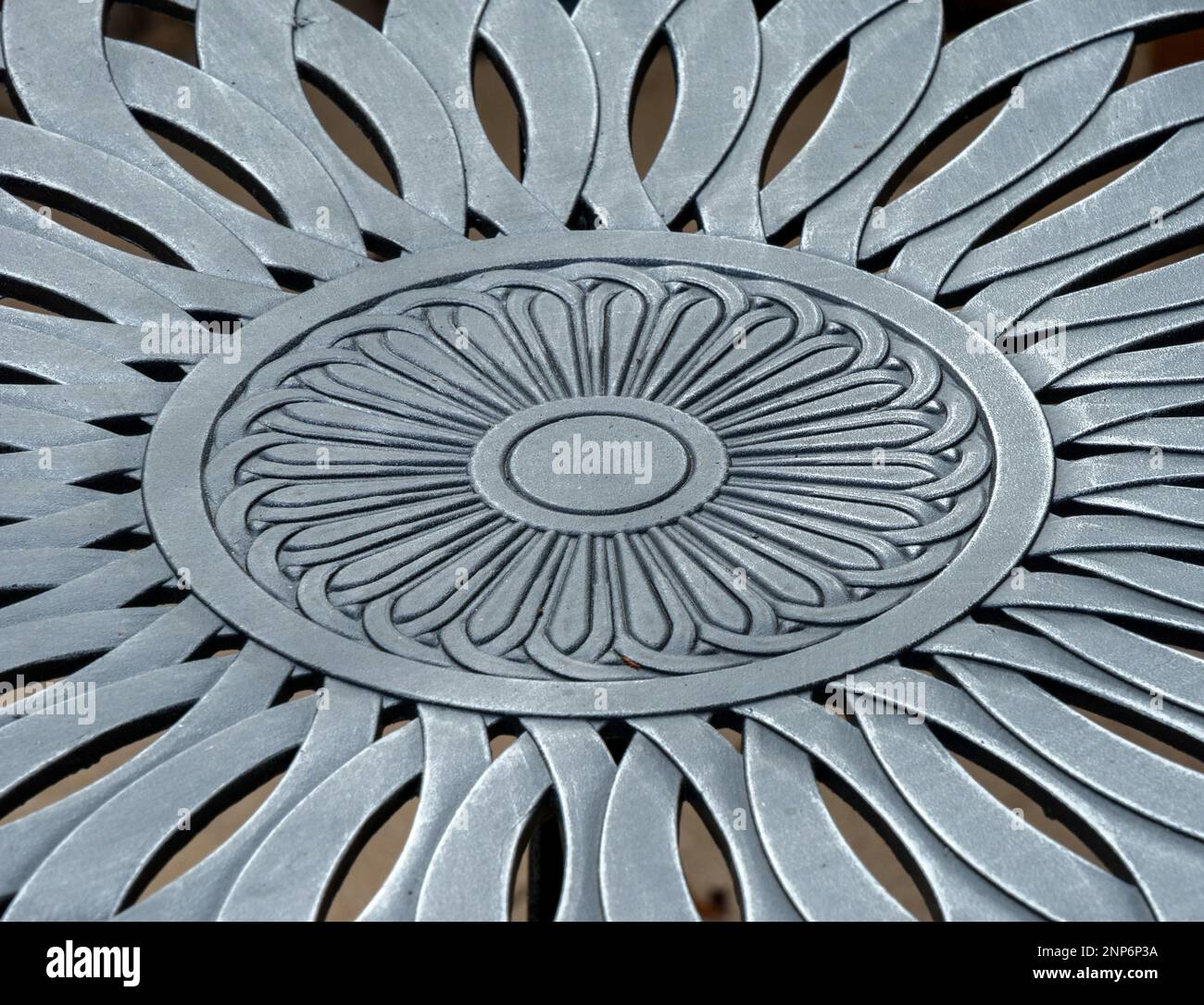 Closeup photo showing detail of floral pattern in cast aluminium metal