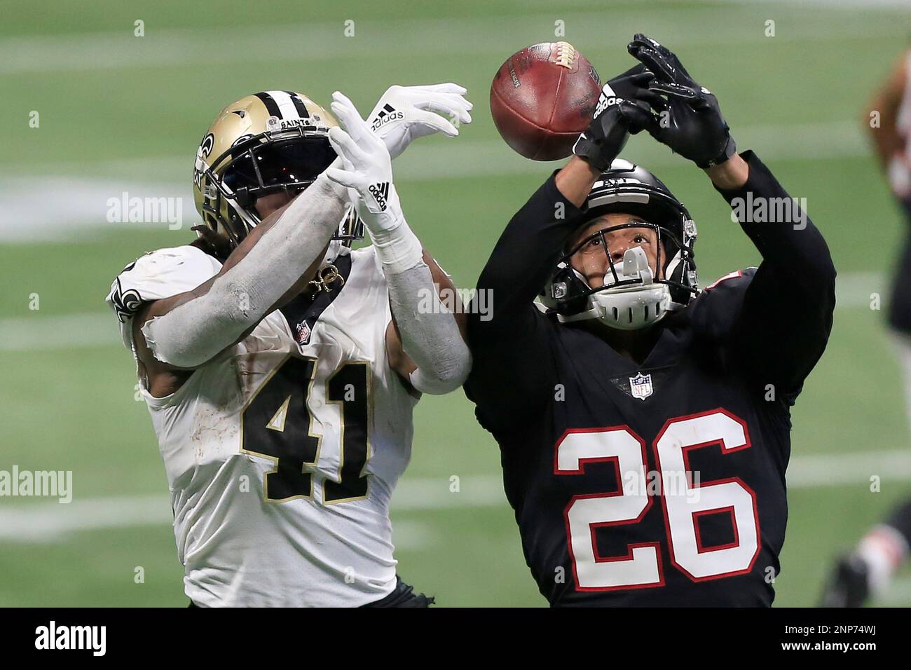 ATLANTA, GA - DECEMBER 06: Cornerback Isaiah Oliver #26 of the Atlanta  Falcons breaks up the pass to Running back Alvin Kamara #41 of the New  Orleans Saints during the week 13