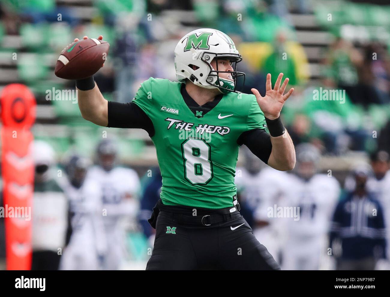 Marshall quarterback Grant Wells makes a throw during an NCAA college