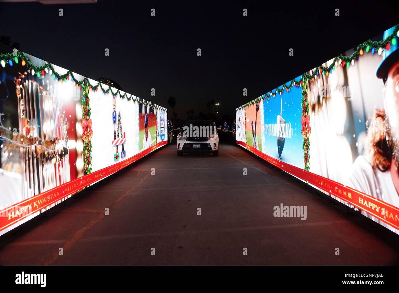 Motorists drive through LED video display at the Los Angeles Dodgers