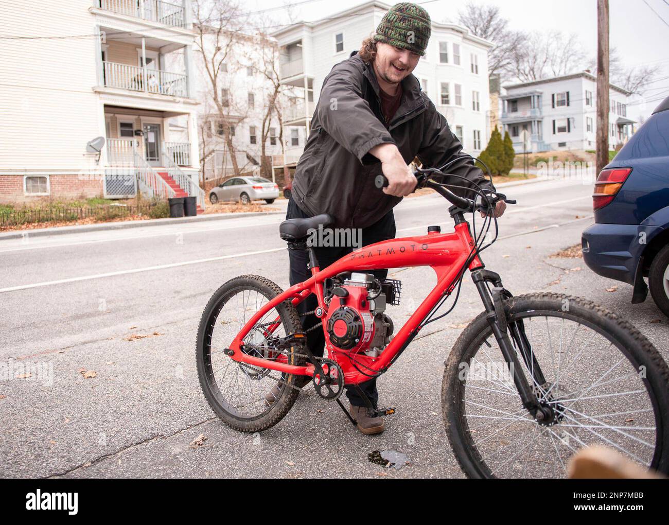Erik Mayle revs up his gas powered bicycle outside of his home in Lewiston Maine Wednesday Dec. 2 2020 after working on the engine. Mayle feels a gas powered bike is more