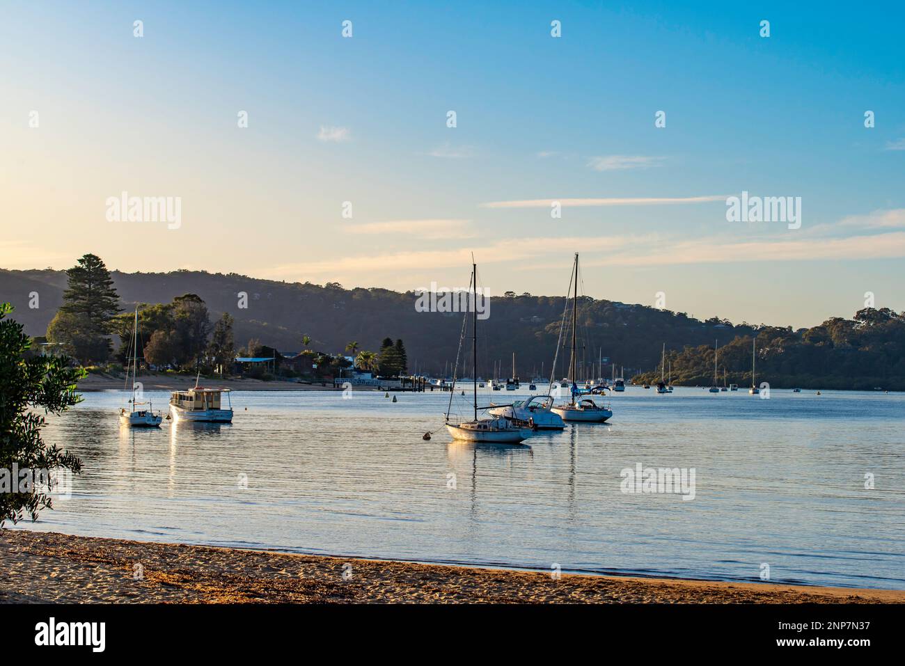 Boats moored in the early morning sunshine at Ettalong Beach on the New South Wales Central Coast in Australia Stock Photo