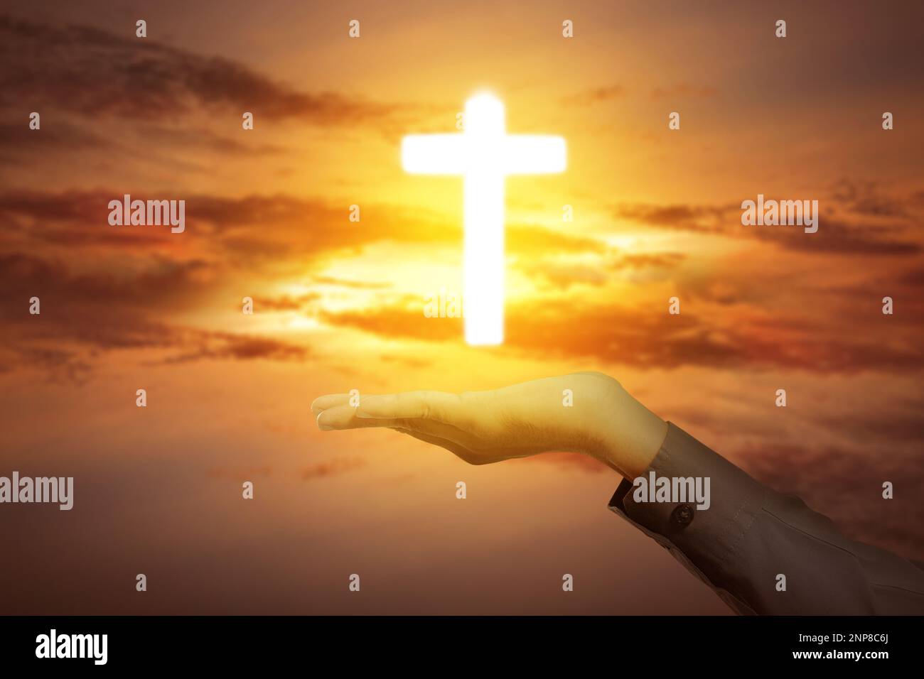Human hand showing Christian cross with sunset sky background Stock ...