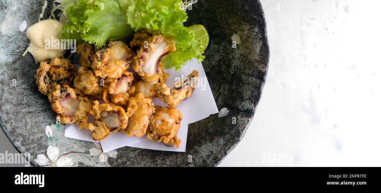 Tako Karaage (Deep fried Octopus), Japanese seafood served on black